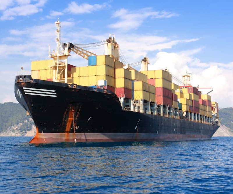 Cargo ship fully loaded with colorful containers at port