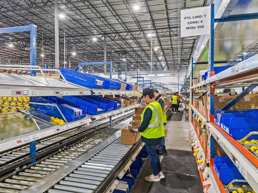warehouse workers packaging and fulfilling orders