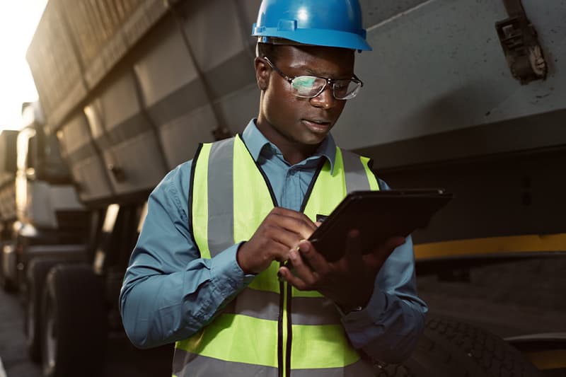 man checking tablet for compliance and risk mitigation